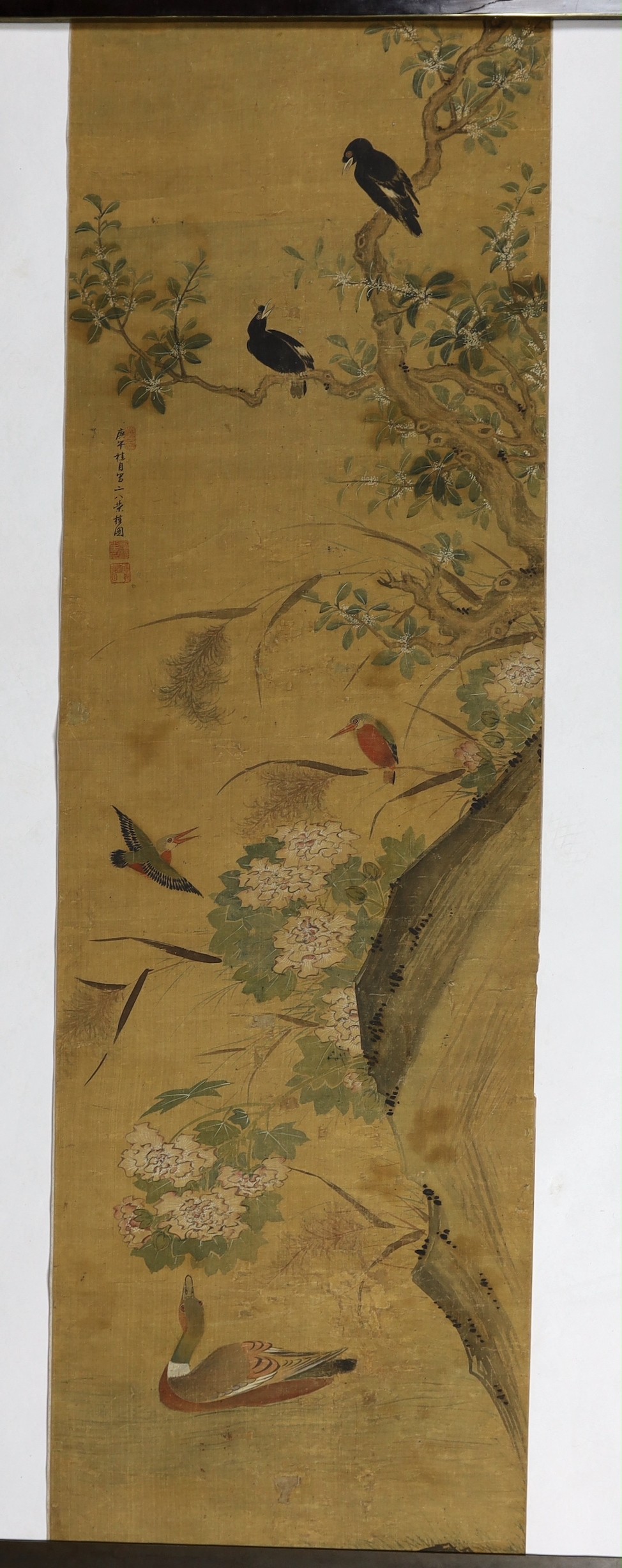 A Chinese scroll painting on silk of birds, rockwork and plants overhanging a pond, 19th century, image 164.5cm x 50.5cm